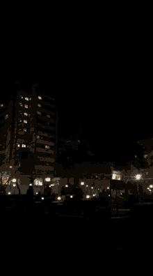a blurry picture of a city at night with a building in the background
