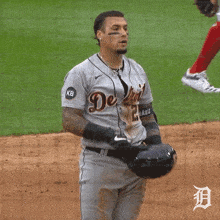a baseball player wearing a jersey that says ' detroit tigers ' on it