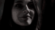 a close up of a woman 's face in the dark .