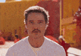 a man with a beard and mustache is wearing a white t-shirt
