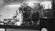 a black and white photo of a drum set with the letter d on the bottom left