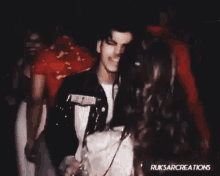a group of people are dancing in a dark room with ruksarcreations written on the bottom right