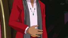 a man wearing a red jacket and a gray scarf stands in front of a tv screen that says bs japan on it