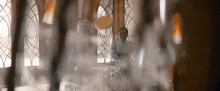 a woman is sitting at a table with smoke coming out of it