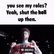 a man in a bulls jersey is holding a sign that says " you see my roles "