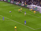 a group of soccer players on a field with advertisements for barclays behind them