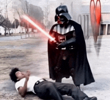 darth vader is standing next to a man on the ground