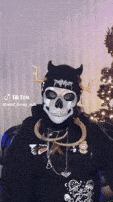 a person wearing a skeleton mask and a devil hat with a tiktok watermark