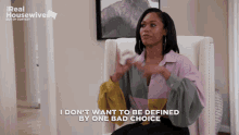 a woman sitting in a chair with the words i don t want to be defined by one bad choice