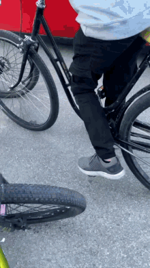 a person is riding a bike next to a green bike