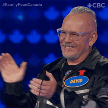 a man with a name tag that says david is clapping