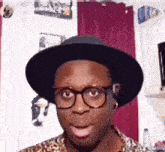 a man wearing glasses and a hat with the name bob on the bottom
