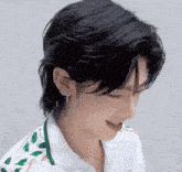 a close up of a person 's face with a mullet hairstyle and earrings .