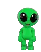 a green stuffed alien with big eyes is standing on a white background .