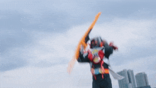 a man in a red and black samurai costume is holding a sword