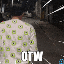 a person wearing a shirt with green eyes and the word otw on the back