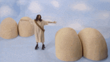 a statue of jesus is standing in front of a bunch of clay balls