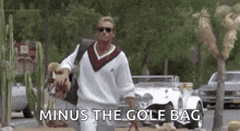 a man is walking down a street carrying a golf bag and a golf club .