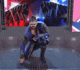 a man in a blue suit and sunglasses kneeling down