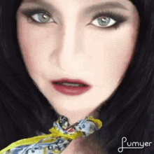 a close up of a woman 's face with plumyer written on the bottom right corner