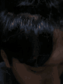 a close up of a person 's face with a black background