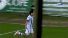 a soccer player with the number 8 on his jersey is running on a field