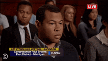 a group of people are watching a live broadcast of a 2015 town hall meeting