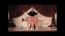 a woman is being lifted into a red box by a man