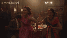 a woman in a pink dress is dancing with another woman in a red dress with the hashtag #mrsmaiset