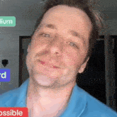 a man in a blue shirt is smiling in front of a sign that says " impossible "