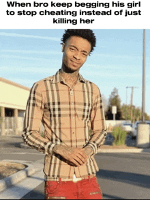 a man wearing a plaid shirt and red pants is standing on a sidewalk