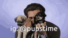a man is holding two puppies in front of his face and says ig @ pupstime