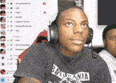 a man wearing headphones and a black shirt that says bama