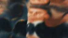 a blurry picture of a man in a suit and tie is being displayed .