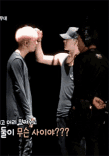 a man with pink hair is standing next to another man