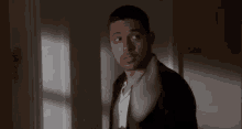 a blurry picture of a man holding a piece of paper in his mouth .