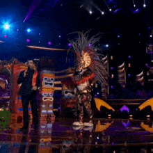 a man in a costume is on stage with a microphone