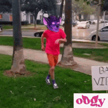 a person with a purple mask on their head is running in front of a sign that says ba video