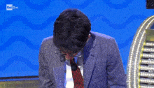 a man in a suit and tie is on a rai 2 hd channel