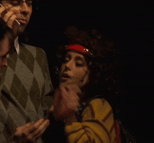 a man talking on a cell phone next to a woman