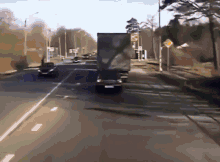 a truck is driving down a highway with a yellow sign that says ' ambulance ' on it
