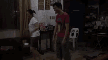 a man and woman are dancing together in a living room .