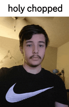 a man with a beard is wearing a nike shirt