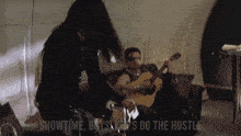 a man playing a guitar next to a woman with the words showtime boys do the hustle