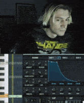 a man wearing headphones and a shirt that says change is playing a keyboard