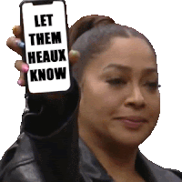 a woman is holding up a cell phone that says " let them heaux know "