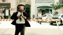a man wearing a suit and tie with a pig head on his head