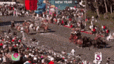 a crowd of people watching a parade with the number 5 on the bottom