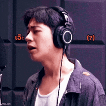 a man wearing headphones with the number 4 on the left