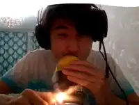 a man wearing headphones is drinking from a can that has the word fla on it